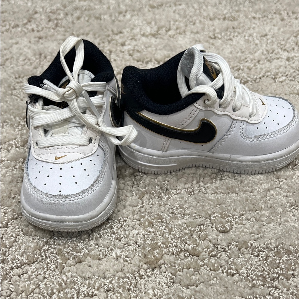 Nike baby Air Force 1 White Sneakers with Black and Gold Accents